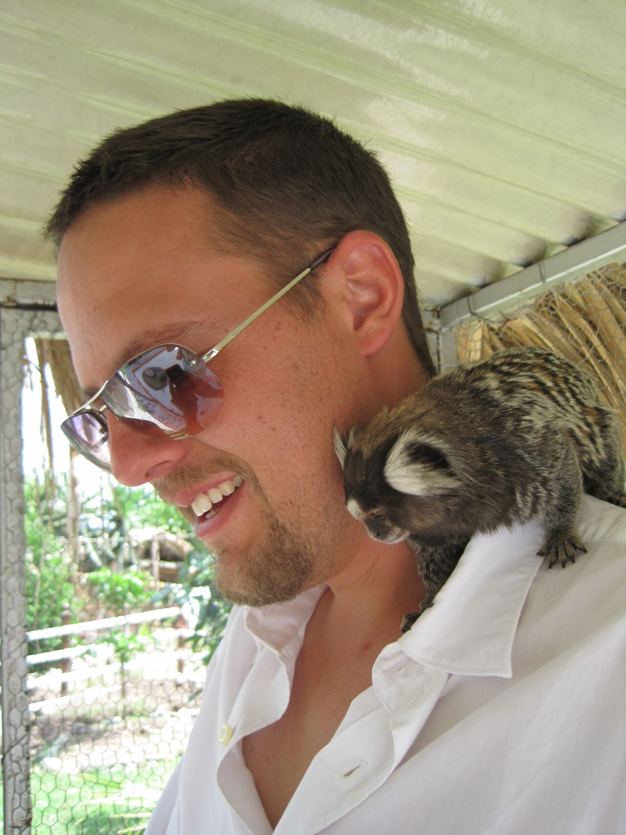 A younger me with a marmoset on my shoulder